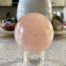 Rose Quartz Crystal Sphere on a countertop